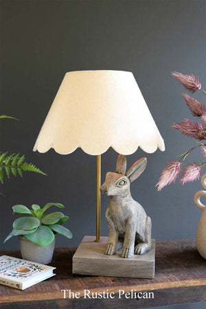 Table lamp with wooden rabbit and scalloped fabric shade